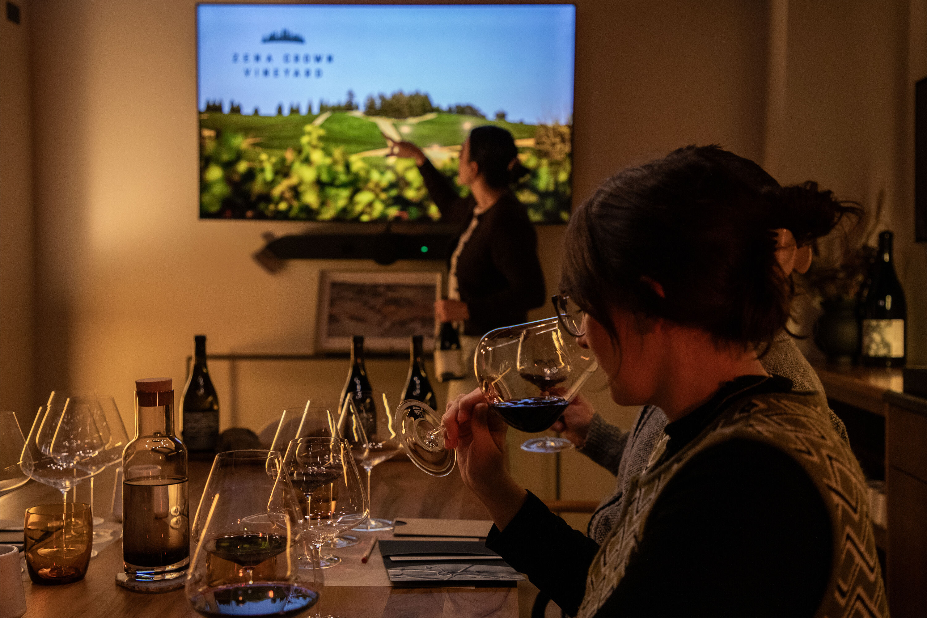 Woman smelling glass of Pinot Noir in private Zena Crown tasting.